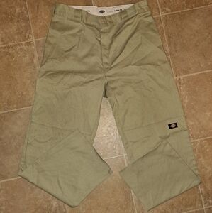 Men's kaki dickies pants cut bottoms stain on back.